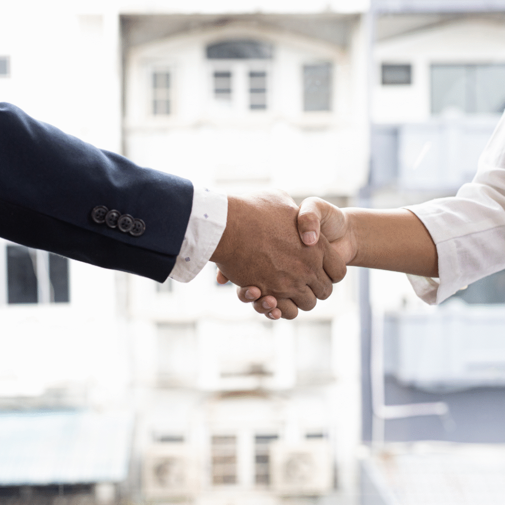 Handshake between two business professionals symbolizing collaboration and partnership in digital marketing.
